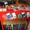 I bought this nightstand for about five dollars at a garage sale.  It was plain wood and rather dull.  I applied a bright red coat of paint and decoupaged pinup art over the top and sides.  It's one of my favorite pieces of furniture.